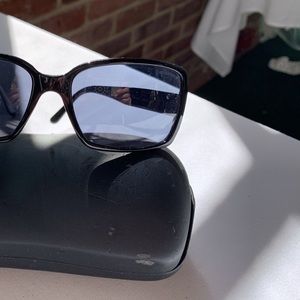 Chanel black sunglasses with silver logo and blue lenses